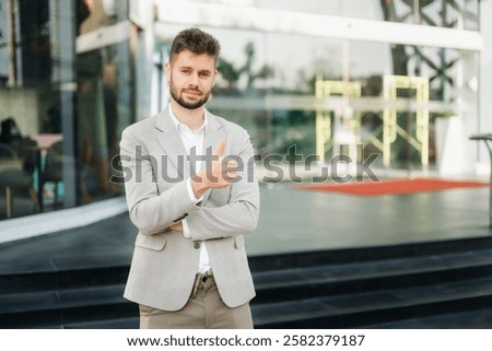 Young  businessman using a tablet  and smartphome on a bench in the city