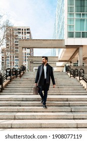 Young Businessman Walking Down A Flight Of Stairs After A Meeting