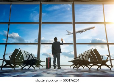 Young Businessman Waving Good Bye At Airport