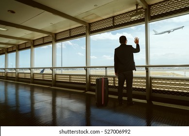 Young Businessman Waving Good Bye At Airport