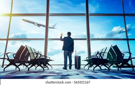 Young Businessman Waving Good Bye At Airport