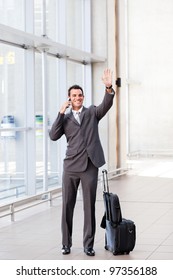 Young Businessman Waving Good Bye At Airport