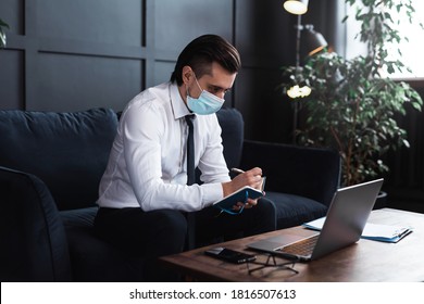 Young businessman wearing prevention mask during his work at home - Shutterstock ID 1816507613
