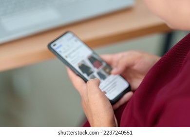 A young businessman wearing a surgical mask is taking a video conference with customers via a smart phone connected to the Internet.	 - Shutterstock ID 2237240551