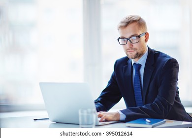 Young businessman working with laptop at office