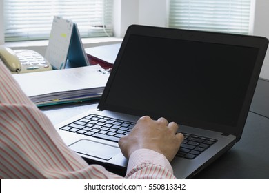 Young businessman working on a laptop - Shutterstock ID 550813342