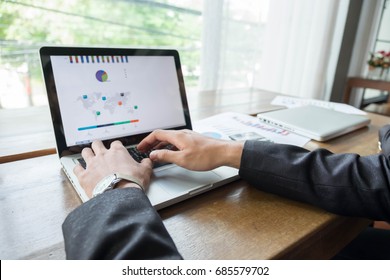 young businessman working on a laptop while sitting at a desk  - Shutterstock ID 685579702
