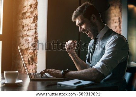 Young businessman working on a plan of Internet project on the laptop. Man discusses business matters by phone. Working computer for internet research. Digital marketing. Development