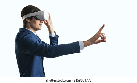 Young Businessman Working In Virtual Reality Office In VR Glasses, Presses His Finger Virtual Interface On Abstract White Backdrop. Innovate And Future Technology Concept, Close Up