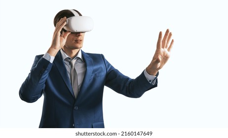 Young Businessman Working In Virtual Reality Office In VR Glasses, Presses His Hand Virtual Interface On Abstract White Backdrop. Innovate And Future Technology Concept, Close Up