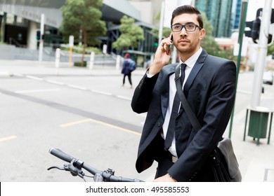 Young businessmen with a bike - Shutterstock ID 495585553