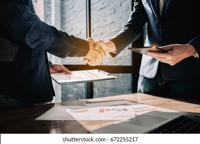 Young businessmen collaborate with partners to increase their business investment network for  Plans to improve quality next month in their office. agreement concept.