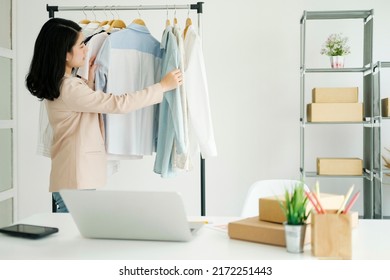 Young Businessowner Checking Clothes In Small Business.Businessman Checking Inventory In Stock Room. Store House Inspection.