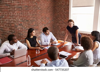 Young Businesswoman Addressing Boardroom Meeting