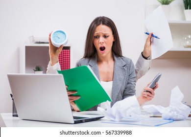 Young businesswoman is angry because she has too much work.