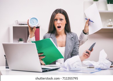 Young businesswoman is angry because she has too much work. 