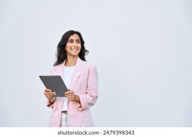 Young businesswoman arabic or indian ethnicity holding digital tablet, looking aside for promo advertising. Israel middle eastern business lady, woman in suit using pc computer, isolated. Copy space - Powered by Shutterstock