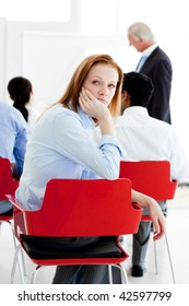 Young Businesswoman Bored At A Conference With Her Colleagues