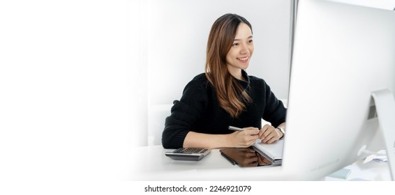 Young businesswoman in casual wear working on desktop computer at home office, copy space. - Shutterstock ID 2246921079