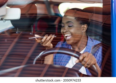 Young businesswoman commuting to work and talking on mobile phone while driving a car. Businesswoman making a phone call while driving to work.  - Powered by Shutterstock