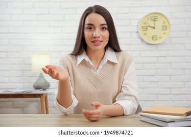 Young Businesswoman Conducting Webinar At Desk In Room