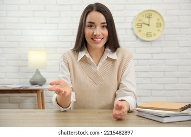 Young Businesswoman Conducting Webinar At Desk In Room