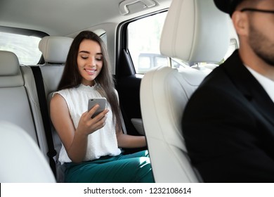 Young Businesswoman With Driver In Luxury Car. Chauffeur Service