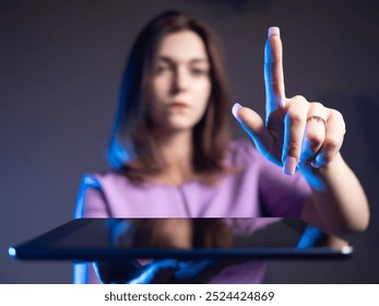 Young businesswoman. Electronic tablet in hands of woman. Girl touches invisible screen with finger. Woman holds tablet with screen facing up. Place to demonstrate business application above gadget - Powered by Shutterstock