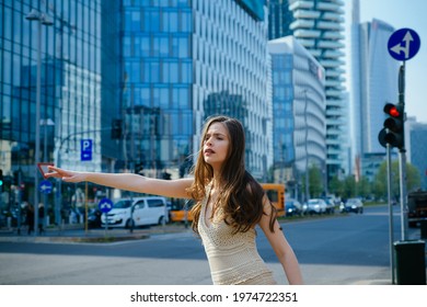 Young Businesswoman Hailing Taxi. Business Woman Catch Taxicar On City Street. Successful And Confident.