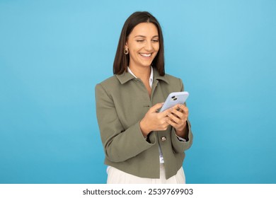 Young businesswoman holding smartphone confidently - Powered by Shutterstock