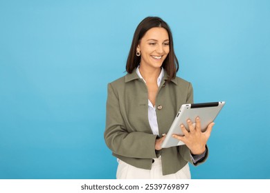 Young businesswoman holding a tablet confidently - Powered by Shutterstock