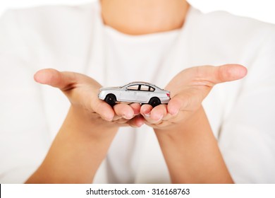 Young Businesswoman Holding A Toy Car.