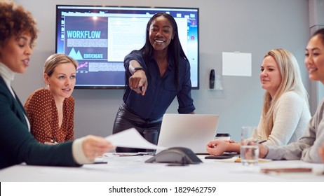 Young Businesswoman Leading Creative Meeting Of Women Collaborating Around Table In Modern Office - Powered by Shutterstock