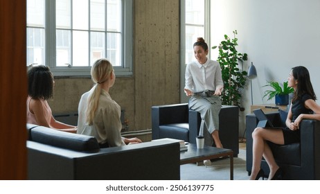 Young Businesswoman Leading Informal Meeting With Female Team Sitting On Sofas In Modern Office - Powered by Shutterstock