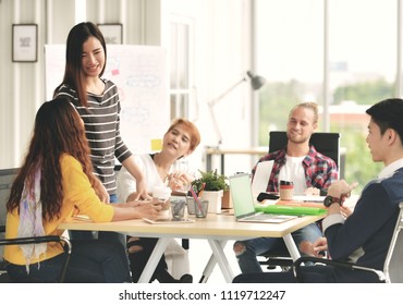 Young Businesswoman Leading A Meeting In Casual Setting At Office