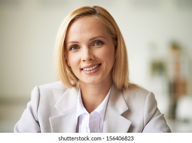 Young businesswoman looking at camera with toothy smile