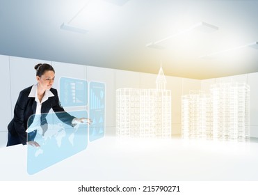 Young businesswoman looking at digital model of construction project - Powered by Shutterstock