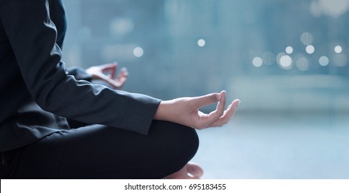 Young businesswoman meditating in office - Powered by Shutterstock