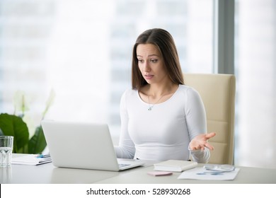 Young Businesswoman At The Modern Office Desk With Laptop Puzzled By A Private Photo Posted, Result Of Election, Salary, World Currency Exchange Rates, Can Not Believe Her Eyes