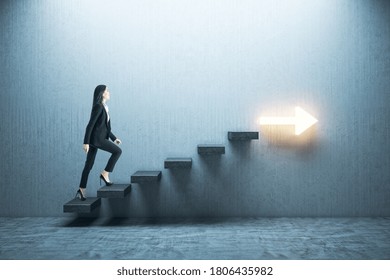 Young Businesswoman Moving Up On Stairs With Arrow On Gray Wall. Leadership And Career Development Concept.