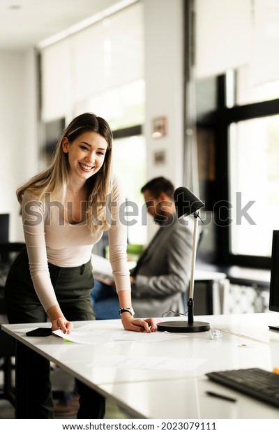 Young\
businesswoman in office organizing\
documents	