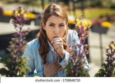 Young Businesswoman On Break Outside Coughing Due To Allergies Or Colds.