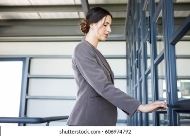 Young Businesswoman Opening Office Door