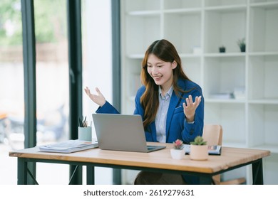 Young businesswoman is preparing to work on a new project involving analyzing data and financial charts on her laptop