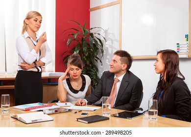 Young businesswoman presenting to partners in meetingroom.