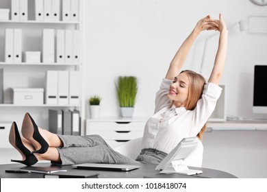 Young businesswoman relaxing in office
