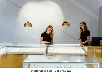 Young businesswoman shop owner doing online selling of jewelry in jewelry boutique. Luxury jewelry store concept. - Powered by Shutterstock