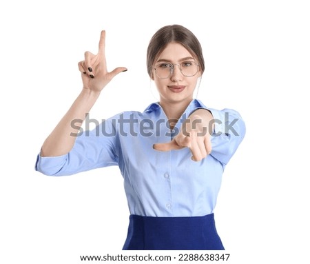 Young businesswoman showing loser gesture and pointing at viewer on white background