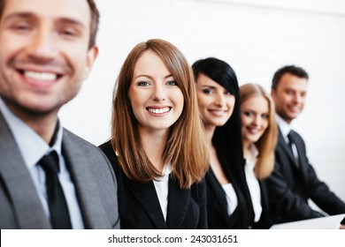 Young businesswoman sitting with business partners. Human resources concept