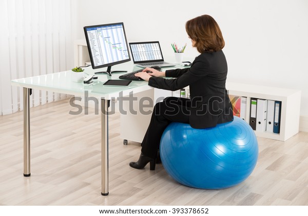 Young Businesswoman Sitting On Pilates Ball People Business